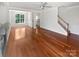 Open floor plan living room showcasing gleaming hardwood floors, and an abundance of natural light at 1184 Lempster Nw Dr, Concord, NC 28027
