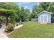 Lush backyard showcasing a shed, pergola with swing, and a well-manicured lawn at 1201 Pegram St, Charlotte, NC 28205