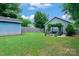 Spacious backyard featuring a shed, pergola with seating, fire pit, and lush green lawn at 1201 Pegram St, Charlotte, NC 28205