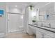 Bright bathroom featuring double sinks, white cabinetry, and a glass-enclosed shower at 1201 Pegram St, Charlotte, NC 28205