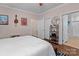 Bedroom with hardwood floors, ceiling fan, and a white comforter with a painting on the wall at 1201 Pegram St, Charlotte, NC 28205