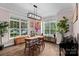 Bright dining room with hardwood floors and views of the green trees outside at 1201 Pegram St, Charlotte, NC 28205