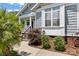 Charming home entrance with landscaped walkway, featuring gray siding and classic architectural details at 1201 Pegram St, Charlotte, NC 28205