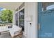 Cozy front porch featuring comfortable seating and a charming blue front door at 1201 Pegram St, Charlotte, NC 28205