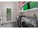 Laundry room featuring a washer and dryer, black tile floor, and built-in shelving at 1201 Pegram St, Charlotte, NC 28205