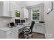 Home office with custom white cabinets, a desk, and a large window at 1201 Pegram St, Charlotte, NC 28205