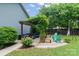 Outdoor living space with a pergola, comfortable seating, a fire pit, and beautiful landscaping at 1201 Pegram St, Charlotte, NC 28205