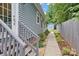 Well-maintained side yard with landscaped pathway leading to a detached shed and fenced backyard at 1201 Pegram St, Charlotte, NC 28205