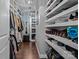 Walk-in closet with open shelving, a mirror, and hardwood floors at 1201 Pegram St, Charlotte, NC 28205