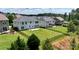 Spacious fenced backyard featuring a large grassy area and mature trees, perfect for outdoor activities at 1281 Arges River Dr, Fort Mill, SC 29715