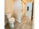 Bright bathroom featuring a white toilet, ceramic tile flooring, and a view of the bath and shower at 1281 Arges River Dr, Fort Mill, SC 29715