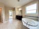 Bright bathroom showcasing a soaking tub and a vanity with granite countertop at 1281 Arges River Dr, Fort Mill, SC 29715