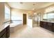 Bright bathroom featuring a soaking tub, glass shower, and double vanity with granite countertop at 1281 Arges River Dr, Fort Mill, SC 29715