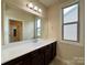 Bathroom with large vanity and sink, large framed mirror, and a window for natural light at 1281 Arges River Dr, Fort Mill, SC 29715