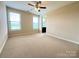 Bright, spacious carpeted bedroom with fan and two windows with natural light and ensuite bathroom at 1281 Arges River Dr, Fort Mill, SC 29715