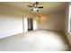 Spacious bedroom with neutral carpet, ceiling fan and open closet doors at 1281 Arges River Dr, Fort Mill, SC 29715