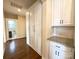 Hallway featuring hardwood floors, white cabinets, and access to other areas of the house at 1281 Arges River Dr, Fort Mill, SC 29715
