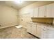 Laundry room with white cabinets and granite countertop at 1281 Arges River Dr, Fort Mill, SC 29715