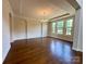 Bright, spacious living room with hardwood floors, large windows, and elegant chandelier lighting at 1281 Arges River Dr, Fort Mill, SC 29715