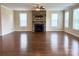Open living area featuring a striking stone fireplace, hardwood floors, and lots of natural light at 1281 Arges River Dr, Fort Mill, SC 29715