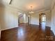Open living room featuring hardwood floors, a tray ceiling, and a seamless flow to other areas at 1281 Arges River Dr, Fort Mill, SC 29715