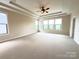 Main bedroom with tray ceiling, fan, and lots of natural light at 1281 Arges River Dr, Fort Mill, SC 29715