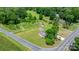An aerial view of the property with the home, barn, outbuildings, and lush green yard at 1300 Nc 90 W Hwy, Taylorsville, NC 28681