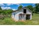 Open barn with a metal roof and sliding door sits on a lush, green field at 1300 Nc 90 W Hwy, Taylorsville, NC 28681