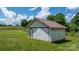 Small barn with a metal roof and sliding door sits on a lush, green field at 1300 Nc 90 W Hwy, Taylorsville, NC 28681