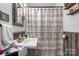 Bathroom with rustic wooden wainscoting and patterned shower curtain, offering style and function at 1300 Nc 90 W Hwy, Taylorsville, NC 28681