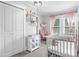 Cozy Bedroom includes a white crib, rocking chair, and shelving for books and toys, creating a comforting space at 1300 Nc 90 W Hwy, Taylorsville, NC 28681