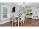 Dining room featuring a rustic chandelier and wood accents, creates a cozy and inviting atmosphere at 1300 Nc 90 W Hwy, Taylorsville, NC 28681