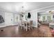 Open dining area with hardwood floors, chandelier, and adjacent living space, ideal for gatherings and entertaining at 1300 Nc 90 W Hwy, Taylorsville, NC 28681