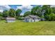 Charming white brick home with a metal roof, detached garage, carport, and well-manicured lawn at 1300 Nc 90 W Hwy, Taylorsville, NC 28681