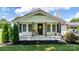 Charming front porch with a 'Welcome' sign and lovely decorative plants and shrubs at 1300 Nc 90 W Hwy, Taylorsville, NC 28681