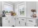 Bright kitchen featuring white cabinetry, contrasting hardware and countertop, with natural light and storage at 1300 Nc 90 W Hwy, Taylorsville, NC 28681