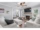 Cozy living room with a brick fireplace, plush seating, and a glimpse into the dining area at 1300 Nc 90 W Hwy, Taylorsville, NC 28681