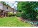 Home's backyard showing green space, foliage, and brick exterior at 1330 5Th Ne St, Hickory, NC 28601