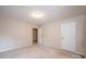 Bedroom with neutral carpet and paint, featuring two doors and ample space for personalization at 1330 5Th Ne St, Hickory, NC 28601