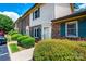 Exterior view of brick and siding townhomes with green shutters, manicured bushes, and blue sky backdrop at 1330 5Th Ne St, Hickory, NC 28601