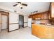 Kitchen featuring vinyl flooring, white appliances, and wooden cabinets for a practical cooking space at 1330 5Th Ne St, Hickory, NC 28601