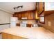 Kitchen with wooden cabinets, white appliances, vinyl flooring, offering a functional cooking space at 1330 5Th Ne St, Hickory, NC 28601