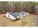 An attractive single-story home featuring a dark roof, white siding, and a spacious yard at 1370 Poole Rd, Salisbury, NC 28146