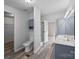 A full bathroom showing dual sinks, a toilet, shower with glass door, and cabinet at 1370 Poole Rd, Salisbury, NC 28146