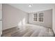 Bright bedroom with modern floors, natural light, and views of the surrounding landscape at 1370 Poole Rd, Salisbury, NC 28146