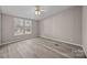 This bedroom features a ceiling fan, neutral walls, and two windows at 1370 Poole Rd, Salisbury, NC 28146