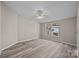 A bright, neutral-toned bedroom has wood-look floors and large windows overlooking the outdoors at 1370 Poole Rd, Salisbury, NC 28146