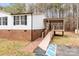Well-maintained home with white siding, a brick foundation, accessible ramp, and a covered back porch at 1370 Poole Rd, Salisbury, NC 28146