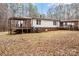 Rear view of the house with siding, a covered porch, and well-maintained landscaping in the backyard at 1370 Poole Rd, Salisbury, NC 28146