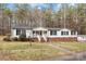 Charming single-story home featuring white siding, a brick foundation, and a welcoming front porch with stair access at 1370 Poole Rd, Salisbury, NC 28146